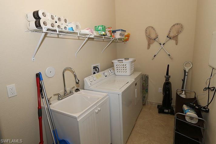 6525 Monterey Point, Unit 203 Naples, FL 34105 - Photo 18 of 25 Clothes washing area featuring light tile patterned flooring and independent washer and dryer