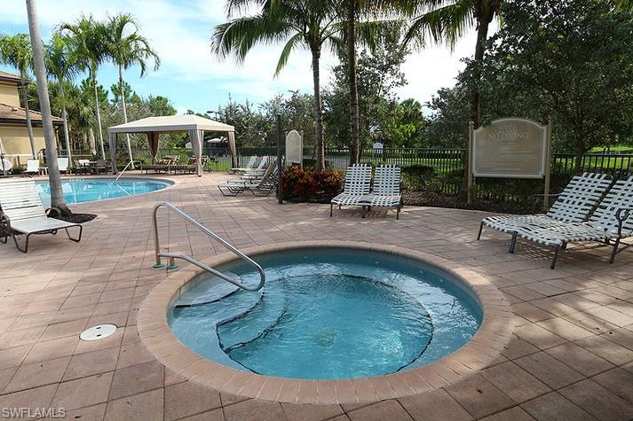 6525 Monterey Point, Unit 203 Naples, FL 34105 - Photo 22 of 25 View of swimming pool featuring a gazebo and a hot tub