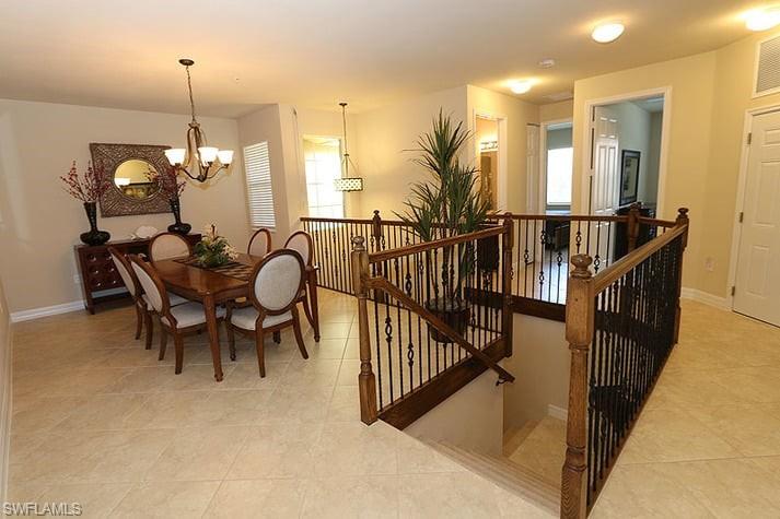 6525 Monterey Point, Unit 203 Naples, FL 34105 - Photo 4 of 25 Dining space with an inviting chandelier and light tile patterned floors