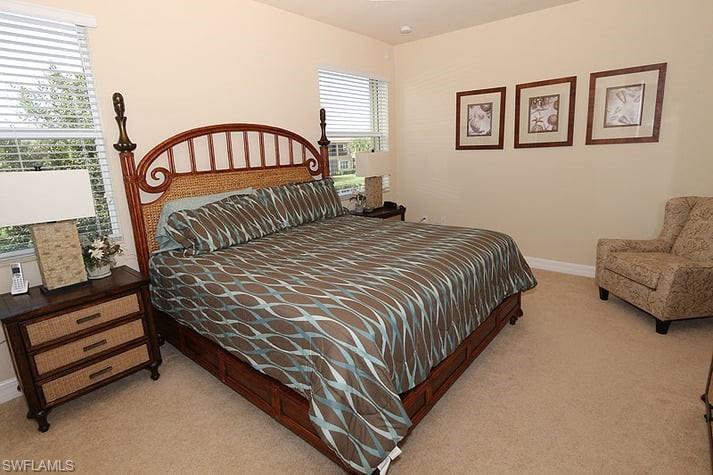6525 Monterey Point, Unit 203 Naples, FL 34105 - Photo 10 of 25 Bedroom with light carpet and multiple windows