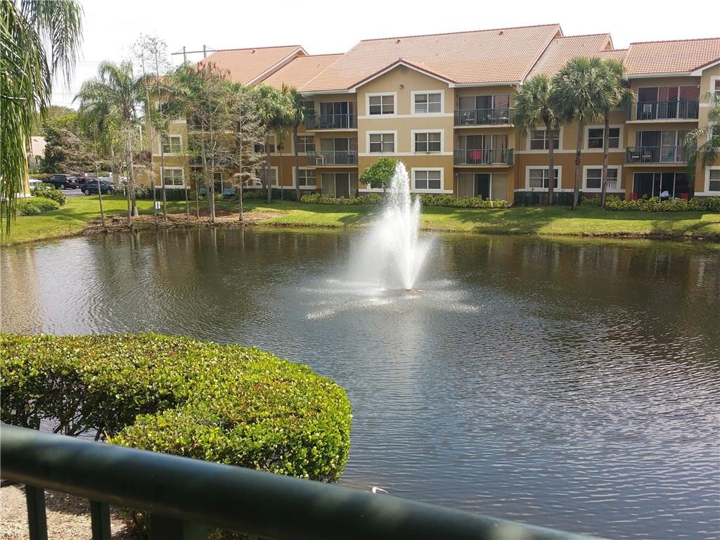 9001 Wiles Road, Unit 206 Coral Springs, FL 33067 - Photo 1 of 14 a view of a lake with houses