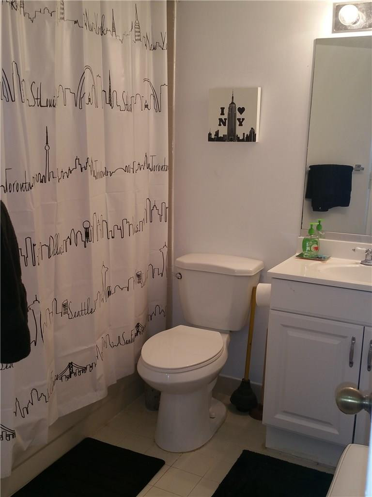 9001 Wiles Road, Unit 206 Coral Springs, FL 33067 - Photo 11 of 14 a bathroom with a toilet and a shower