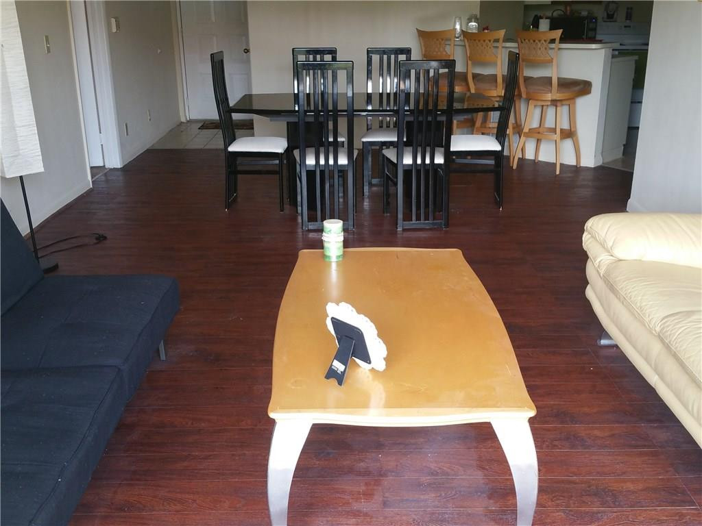 9001 Wiles Road, Unit 206 Coral Springs, FL 33067 - Photo 4 of 14 a view of a dining room with furniture and wooden floor