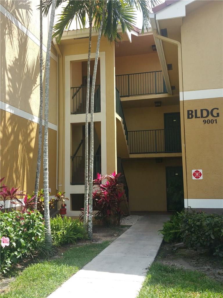 9001 Wiles Road, Unit 206 Coral Springs, FL 33067 - Photo 7 of 14 a front view of a house with a garden