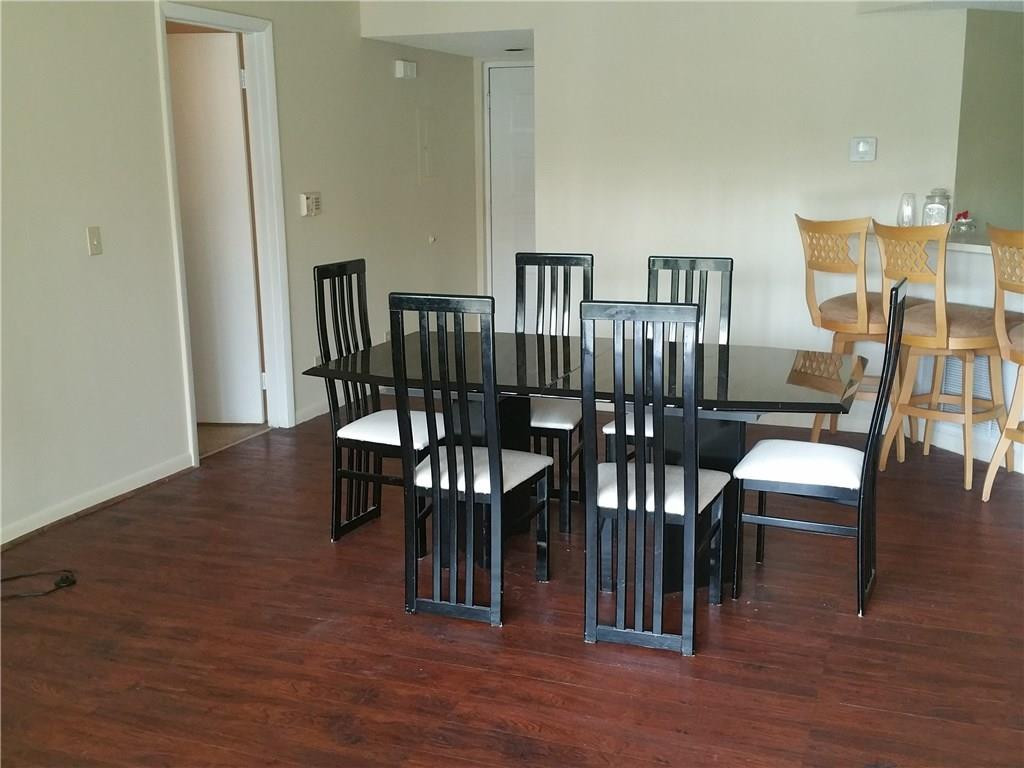 9001 Wiles Road, Unit 206 Coral Springs, FL 33067 - Photo 10 of 14 a view of a dining room with furniture and wooden floor
