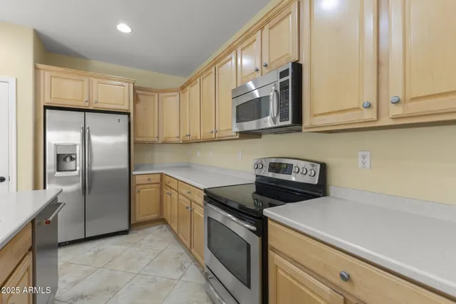 a kitchen with stainless steel appliances granite countertop white cabinets a sink and dishwasher