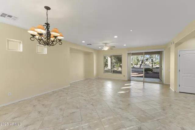 a kitchen with stainless steel appliances a stove a sink a refrigerator and white cabinets with wooden floor