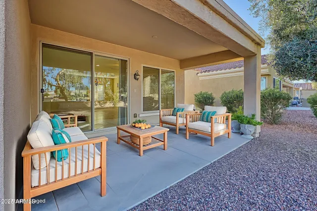 a view of a house with porch and garden
