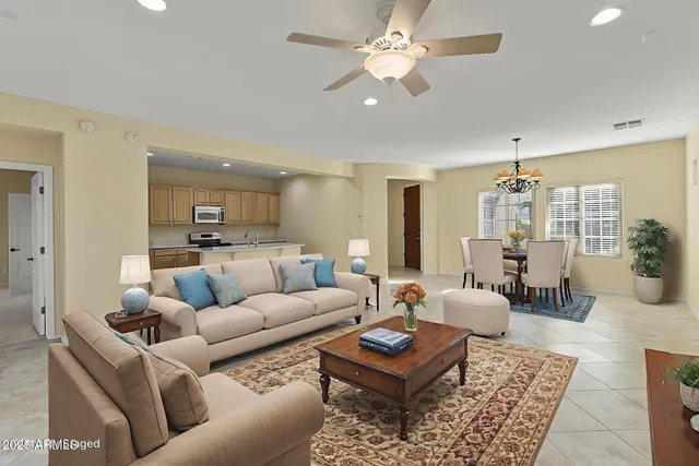 a view of a big room with chandelier and windows