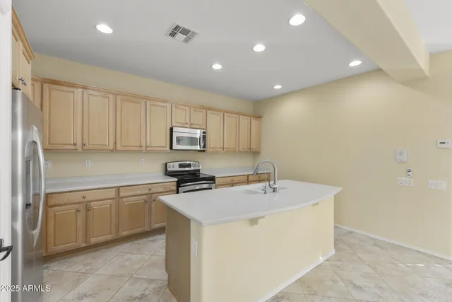 a kitchen that has a sink a stove and cabinets