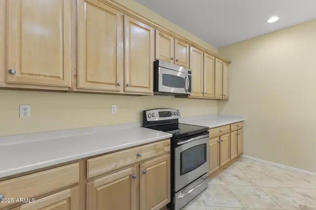 a kitchen with stainless steel appliances a sink stove and cabinets