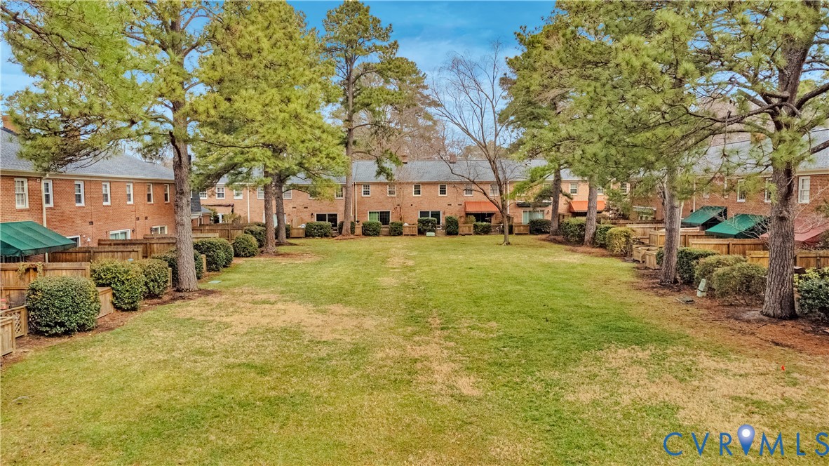 9111 Derbyshire Road, Unit G Henrico, VA 23229 - Photo 38 of 42 a view of a yard with a house and large trees