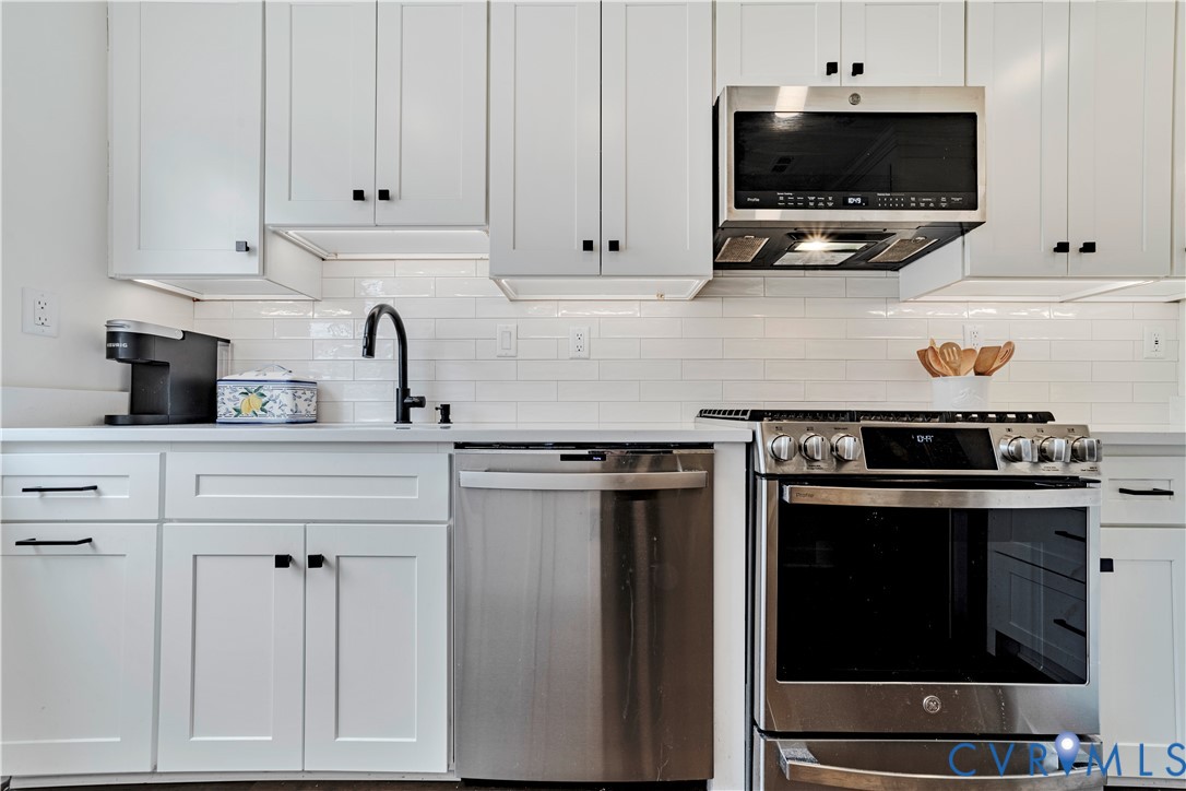 9111 Derbyshire Road, Unit G Henrico, VA 23229 - Photo 4 of 42 a kitchen with stainless steel appliances a stove a microwave and sink