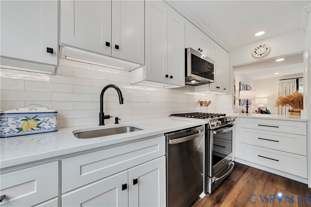 9111 Derbyshire Road, Unit G Henrico, VA 23229 - Photo 7 of 42 a kitchen with stainless steel appliances granite countertop a sink and a stove