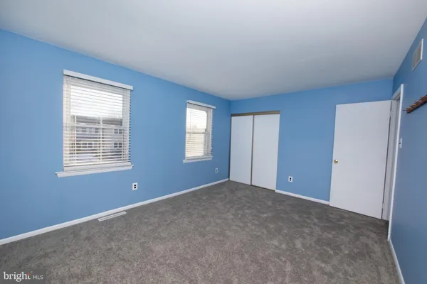 a view of an empty room with windows