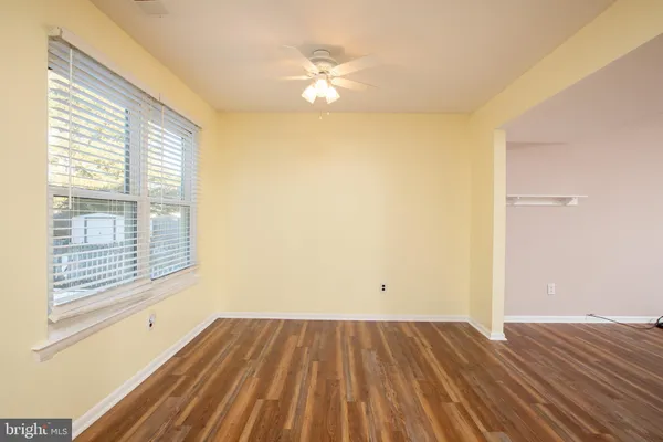 a view of a room with wooden floor and a window