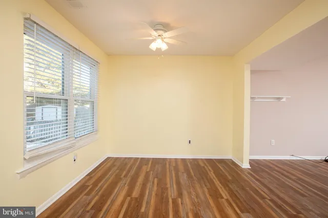 a view of a room with wooden floor and a window