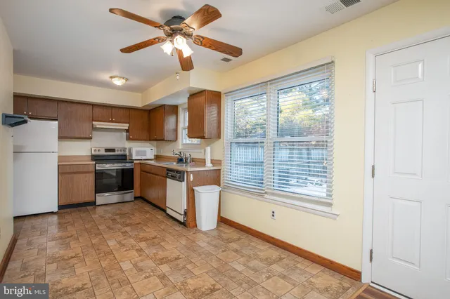 a kitchen with a stove a sink and a refrigerator