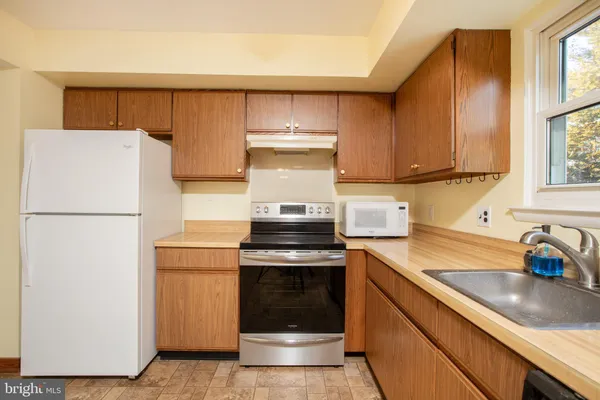 a kitchen with a stove top oven and cabinets