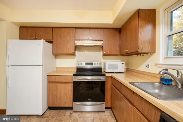 a kitchen with a stove top oven and cabinets