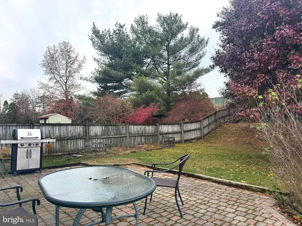 a view of a chairs and table in backyard