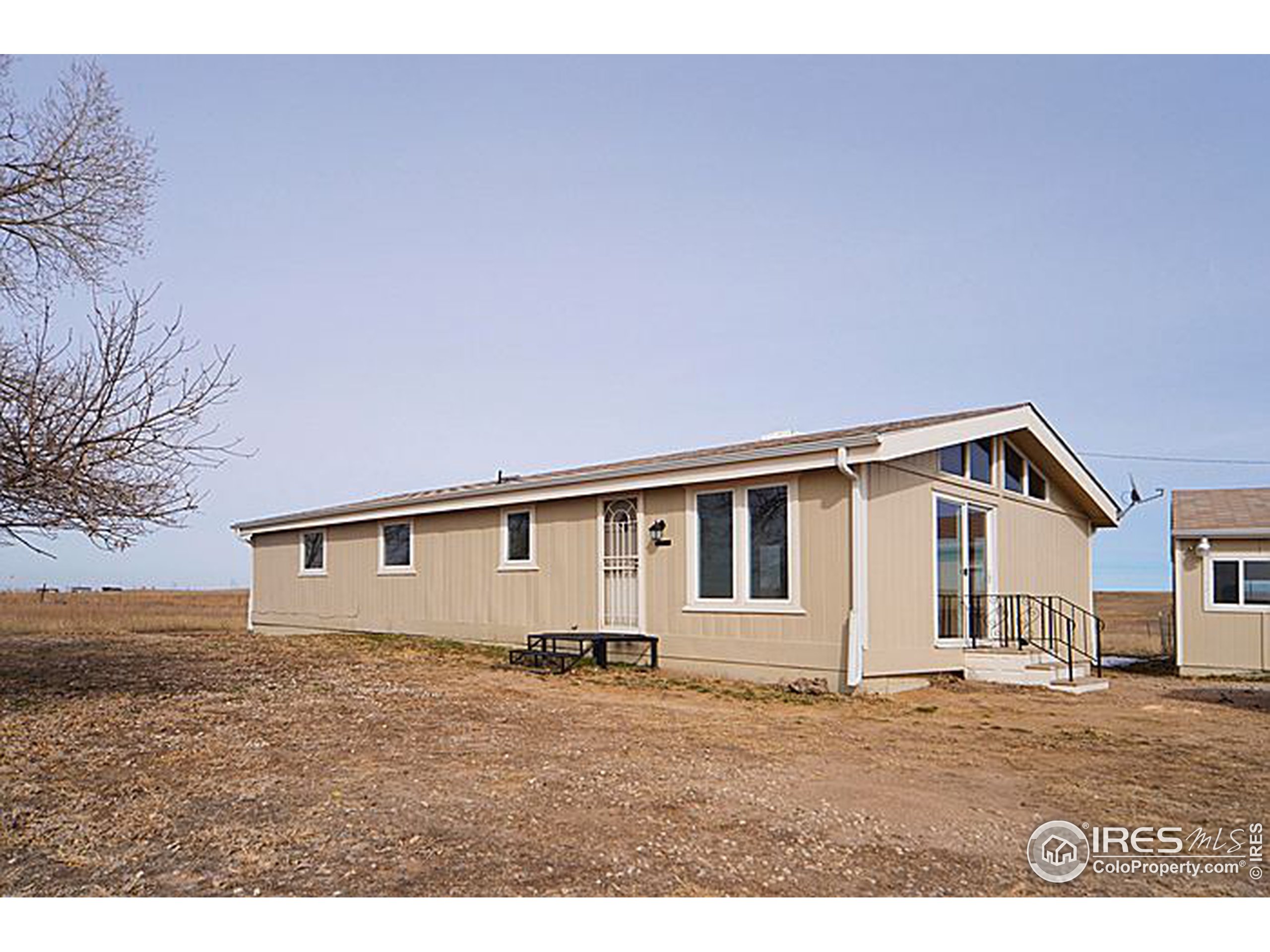 8966 County Road Hudson, CO 80642 - Photo 1 of 25 a view of a house with backyard and wooden fence