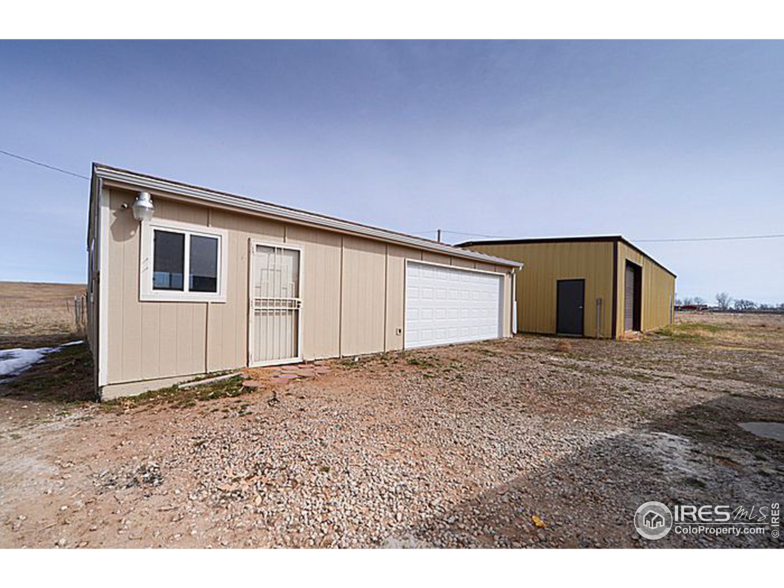 8966 County Road Hudson, CO 80642 - Photo 23 of 25 a view of a house with a backyard