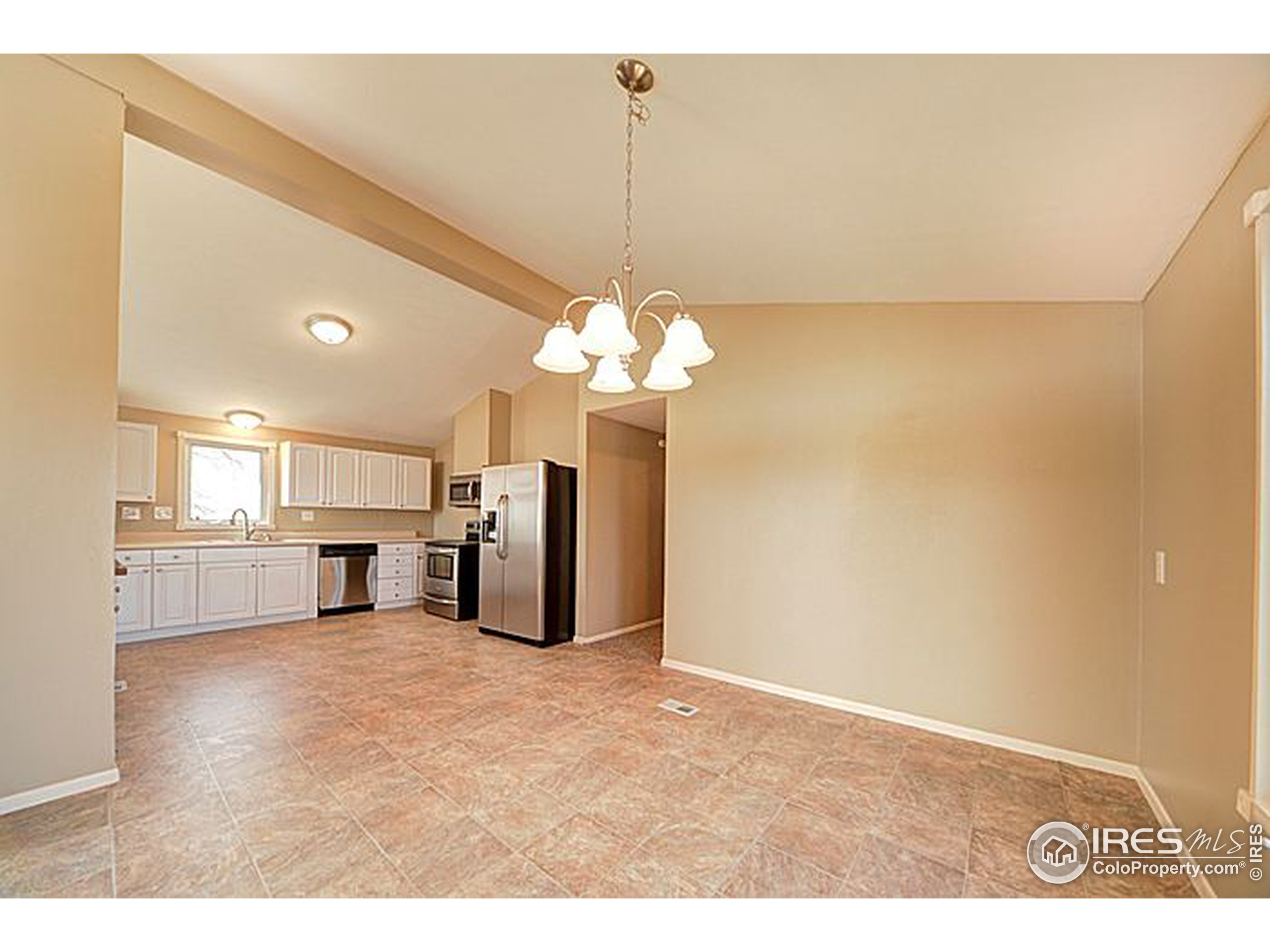 8966 County Road Hudson, CO 80642 - Photo 3 of 25 a view of a kitchen with a refrigerator a sink and dishwasher