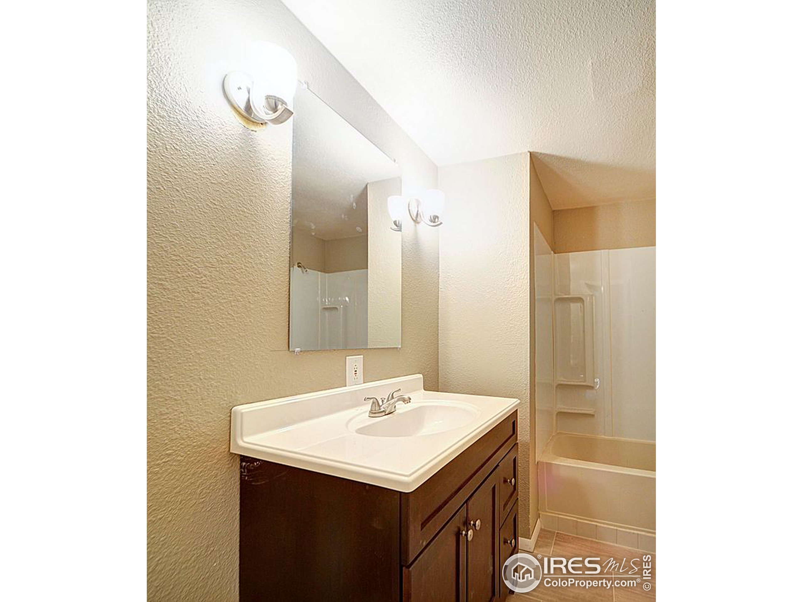 8966 County Road Hudson, CO 80642 - Photo 5 of 25 a bathroom with a sink and a mirror