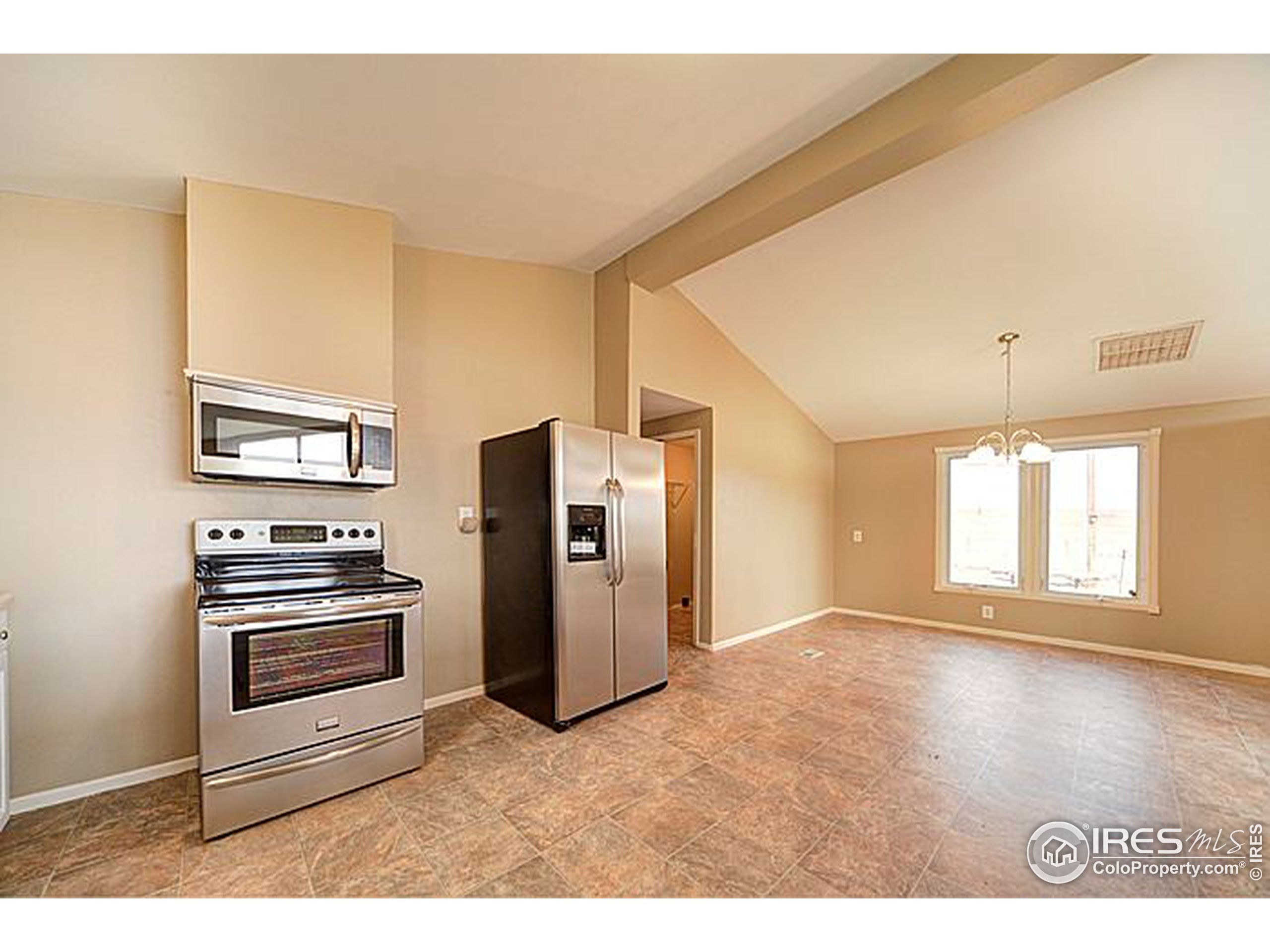 8966 County Road Hudson, CO 80642 - Photo 7 of 25 a kitchen with refrigerator and window