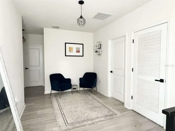 a bedroom with a large bed and a painting on the wall