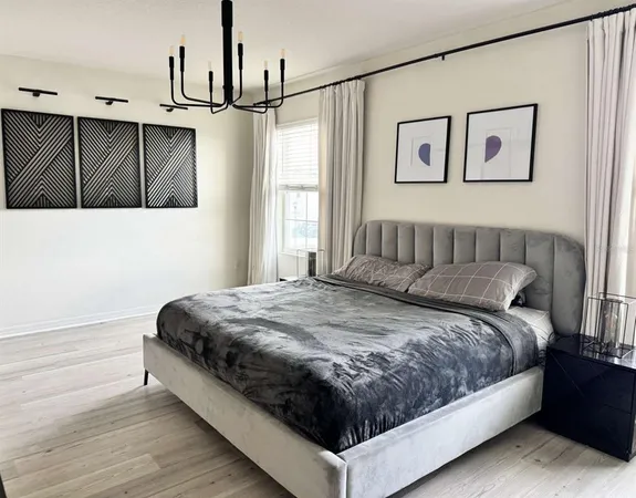 a living room with a flat screen tv and a ceiling fan