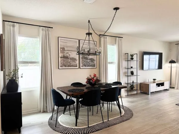 a dining room with furniture and window