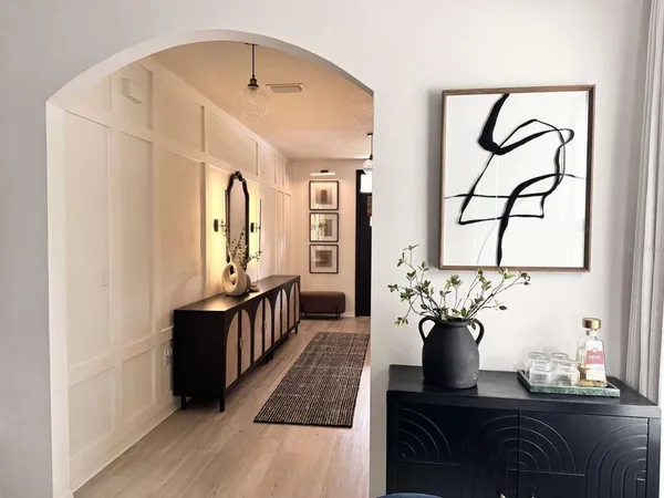 a living room with furniture and wooden floor