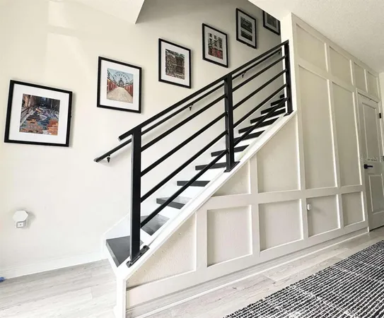 a view of staircase with wooden floor and white door