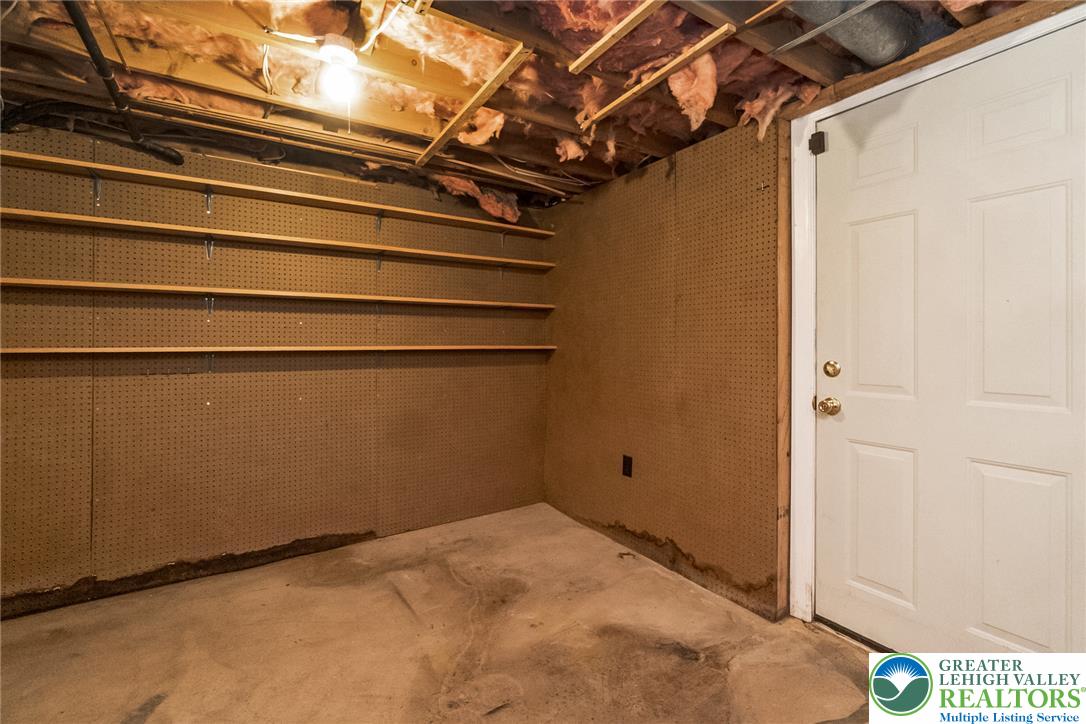 268 Apollo Drive Bethlehem, PA 18017 - Photo 44 of 56 Functional basement space with exposed ceiling joists and convenient wall shelving, ideal for storage.