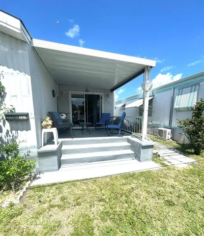 a view of a patio with couches chairs and potted plants
