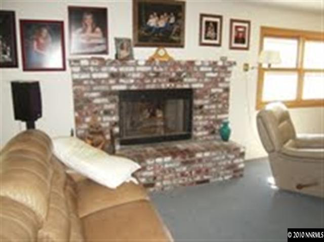 550 Holcomb Ranch Lane Reno, NV 89511 - Photo 3 of 7 a living room with furniture and a fireplace