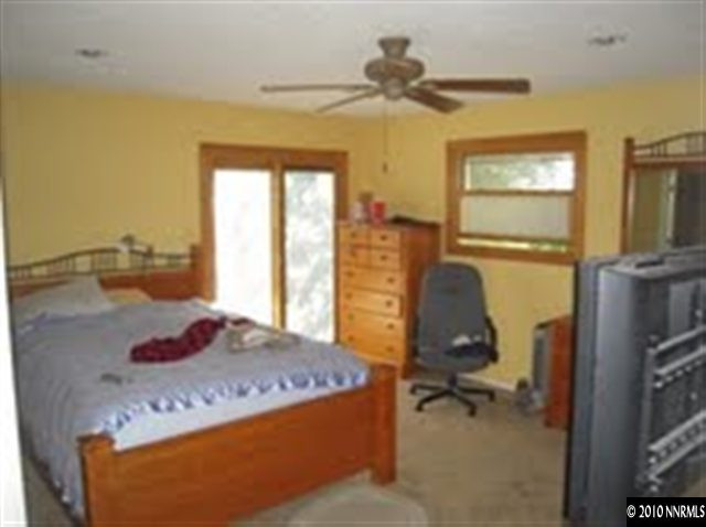 550 Holcomb Ranch Lane Reno, NV 89511 - Photo 4 of 7 a living room with a bed furniture and a window