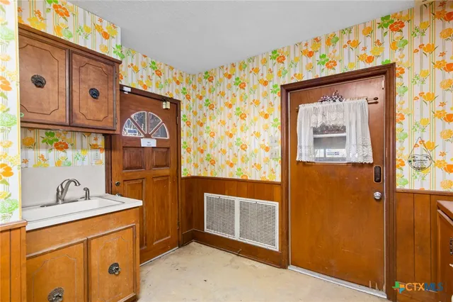 a kitchen with stainless steel appliances granite countertop a stove and cabinets