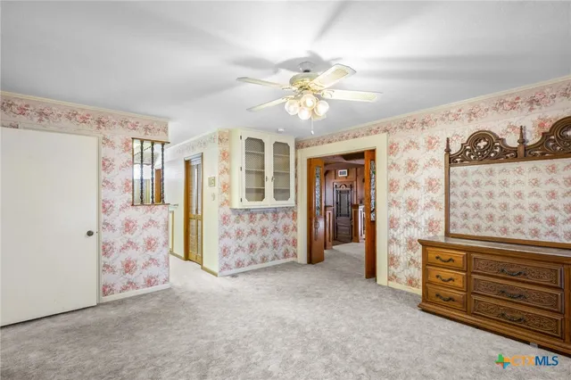 a room with pool table and windows