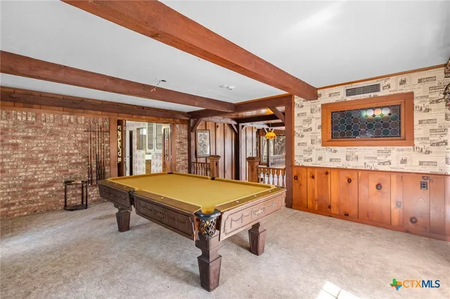 a view of a bedroom with furniture and window