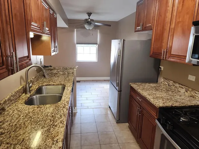 a kitchen with a sink stove and refrigerator