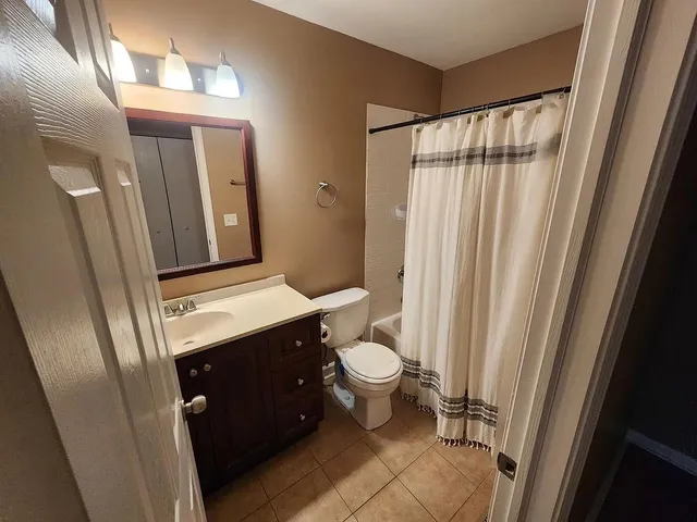 a bathroom with a sink vanity mirror and toilet
