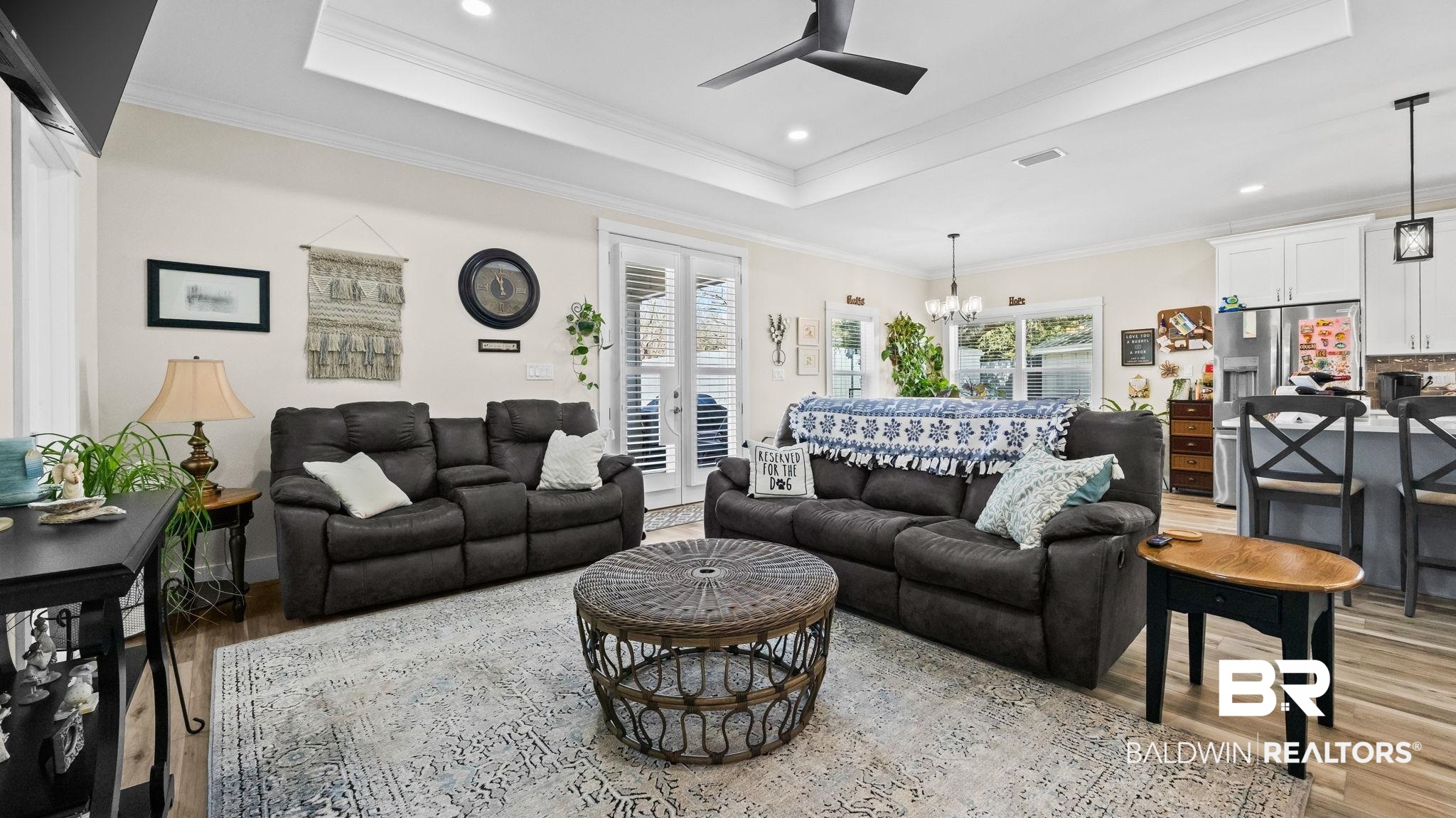 8013 Carmel Circle Foley, AL 36535 - Photo 5 of 49 Living area featuring light wood-style floors, a chandelier, ceiling fan, a raised ceiling, and ornamental molding
