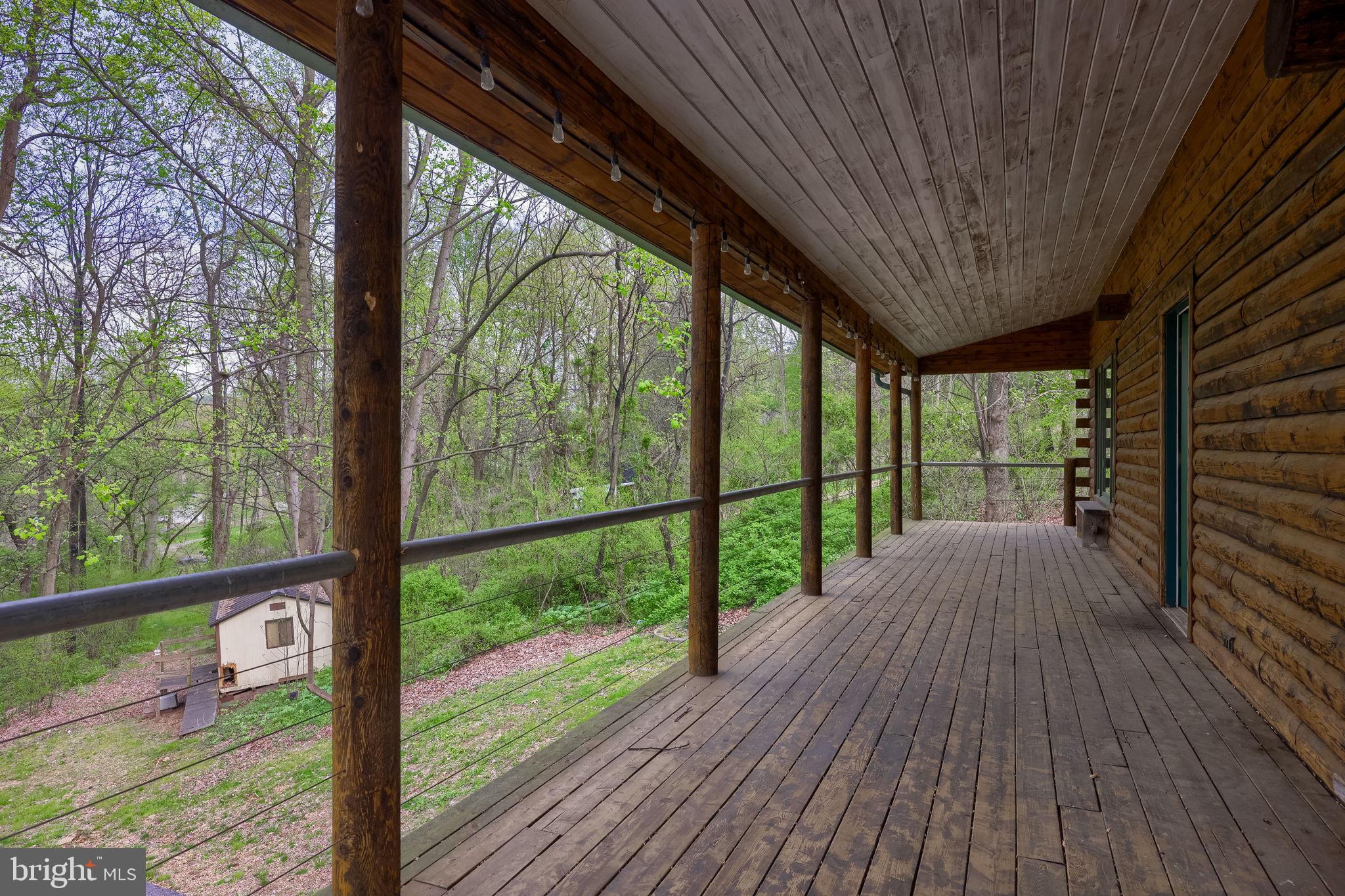 171 Fox Hollow Road Pequea, PA 17565 - Photo 6 of 28 Serene porch overlooking lush greenery.