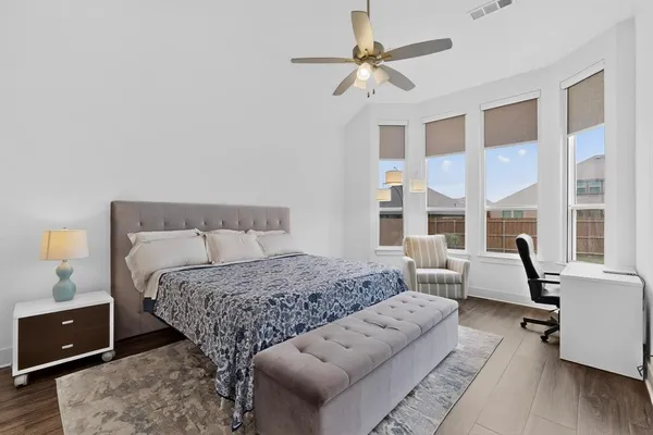 a bedroom with a large bed and a couch