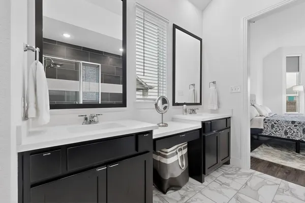 a bathroom with a sink double vanity and a mirror
