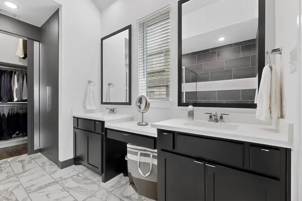 a bathroom with a double vanity sink a and mirror
