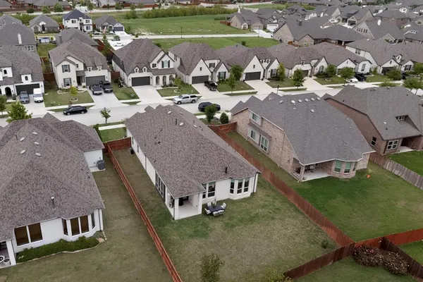 an aerial view of a house with garden space and street view